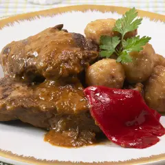 Tierna ternera guisada con patatas, acompañada de pimiento rojo y perejil. Un plato casero y delicioso.