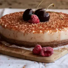 Tarta de queso con leche condensada, cubierta de frutos rojos y virutas de chocolate. ¡Un postre irresistible!