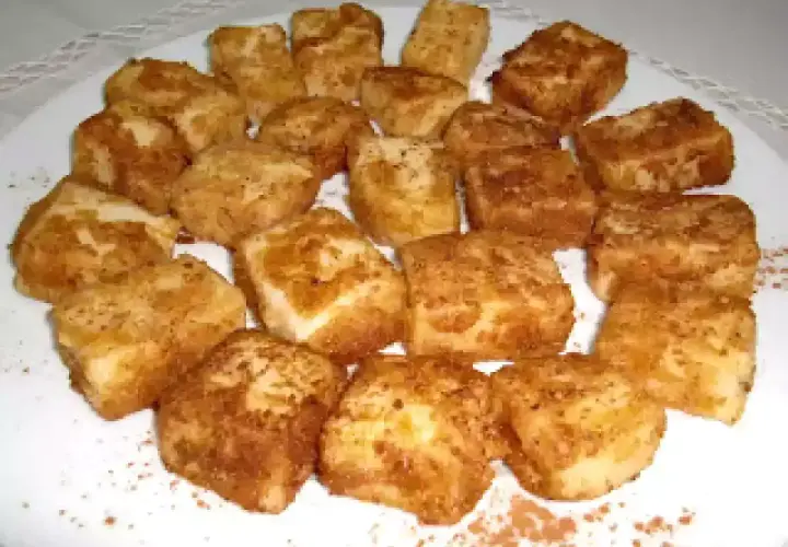 Deliciosa leche frita Thermomix, dorada y espolvoreada con canela, lista para disfrutar.