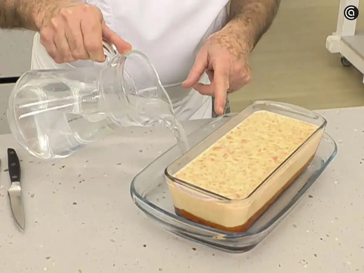Vertiendo agua en un molde con flan de calabaza Argui&ntilde;ano.